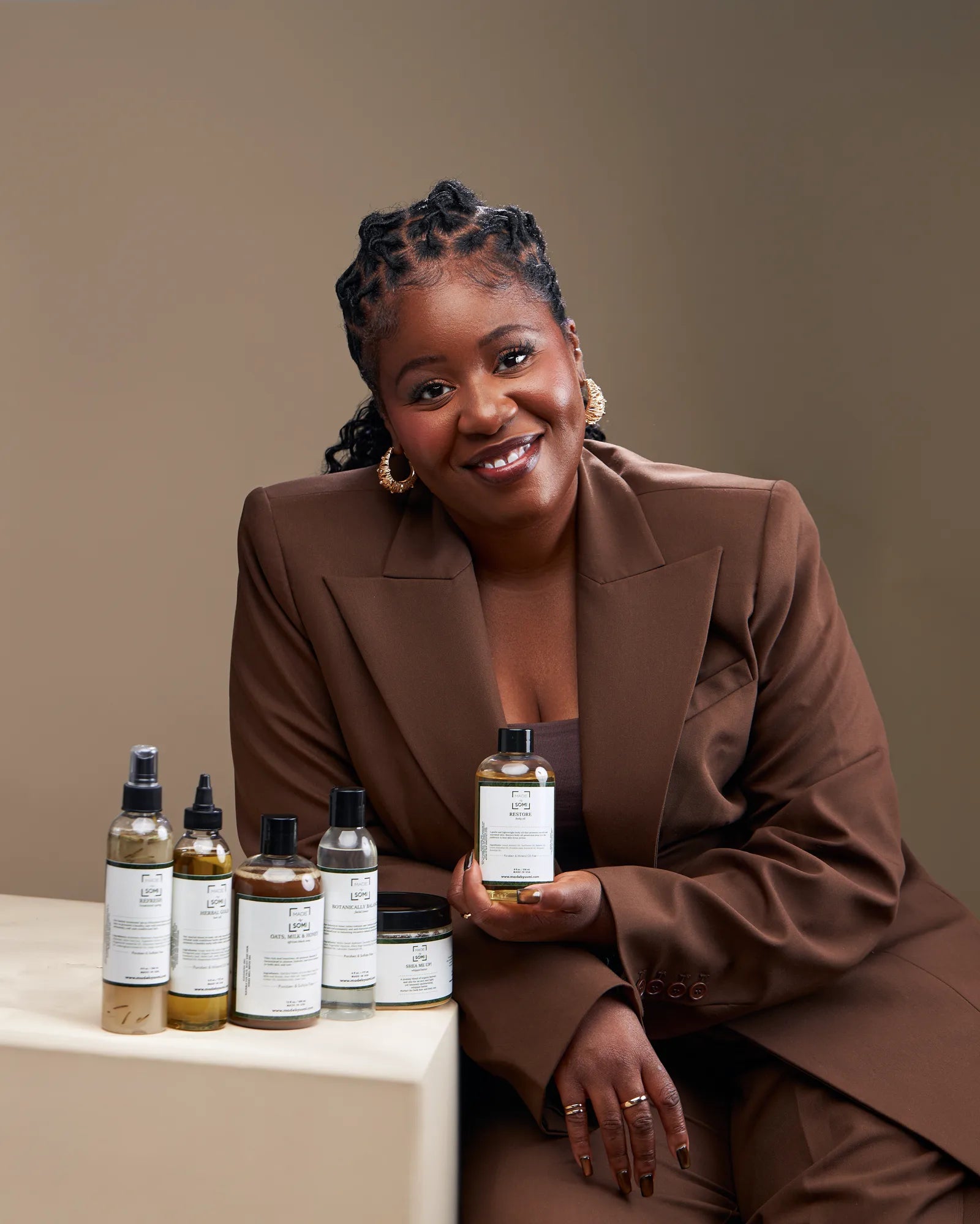 Dr. Omosude Kerobo, founder of Made by SOMI, with the product collection